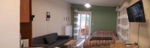 a living room with a couch and a tv at Xara' s studio in Kozani