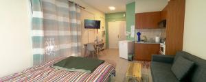 a small room with a bed and a kitchen at Xara' s studio in Kozani