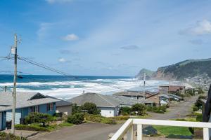 a view of a town with the ocean and houses at The Tides Inn in Lincoln City