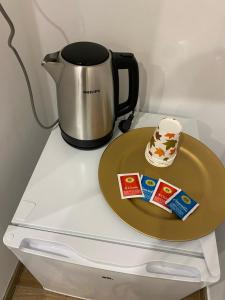 a coffee pot and a plate on top of a refrigerator at La casa di nonna chella in Bari +13 photos