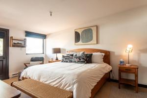 a bedroom with a large bed with white sheets and pillows at Christophe Condo 712 in Ketchum +21 photos