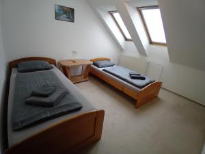 two twin beds in a room with a window at U vodohospodárov in Banská Štiavnica +85 photos
