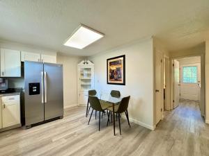 a kitchen with a table and a stainless steel refrigerator at Idle Springs in Marion