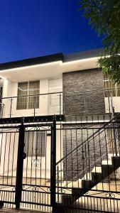 a black fence in front of a building at Casa Boutique Las Acacias in Valledupar