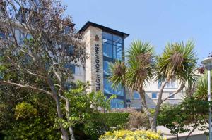 a building with palm trees in front of it at Town House Creeslough in Creeslough