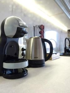 a coffee pot and a tea kettle on a counter at Apartment Sweet Pear with garage in Armação de Pêra