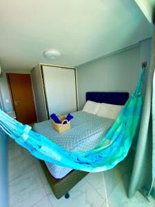 a bed with a hammock in a room at Flat premium centro de Porto de Galinhas-Makambira Residence-Flat309 in Porto De Galinhas