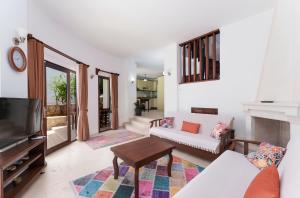 a living room with a couch and a tv at Villa Erel in Kas