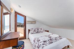 a bedroom with a bed and a desk and a window at Villa Erel in Kas +34 photos