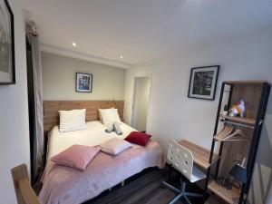a bedroom with a bed with pillows on it at La maison de Jean in Saint-Flour