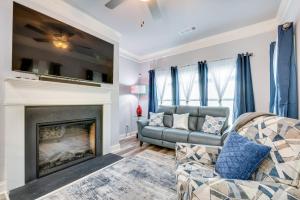 a living room with a couch and a fireplace at Atlanta Home with Patio, 8 Mi to Downtown and Aquarium in Atlanta