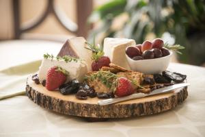 a plate of cheese and fruit on a table at The Chadwick Bed and Breakfast in Portland