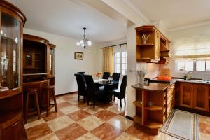 a kitchen and dining room with a table and chairs at Villa Rose by AnaLodges in São Vicente