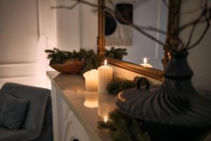 a table with candles and a mirror on it at Ikigai Tivat Parisian Apartment in Tivat