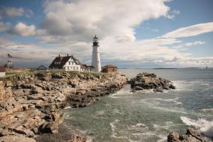 a lighthouse on top of a rocky cliff at The Chadwick Bed and Breakfast in Portland