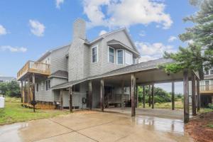 a large house with a gambrel roof at The Powell at Ships Watch in Duck