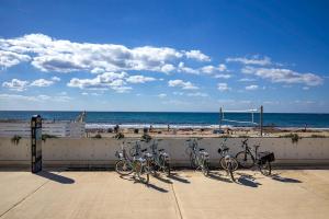a group of bikes parked next to a fence at the beach at Orange Tree Studio, just steps from the sea in Paphos City