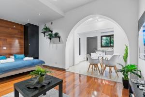 a bedroom with a bed and a dining room at Orange Tree Studio, just steps from the sea in Paphos City