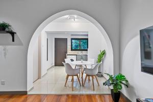 a dining room and kitchen with a table and chairs at Orange Tree Studio, just steps from the sea in Paphos City