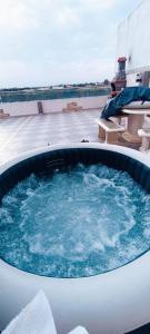 a hot tub on top of a building at Appartement entier avec Terasse, Hammam, BBQ in Alger