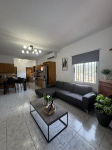 a living room with a couch and a table at Mythos House in Episkopi Pafou