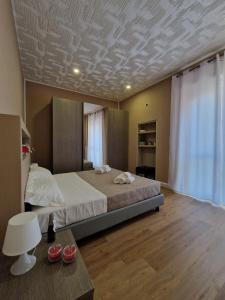 a bedroom with a large bed and a table at Tiffany Home in Matera