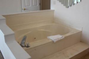 a white bath tub with a towel in a bathroom at 2 Bed Lakefront Condo at The Lake of the Ozarks in Lake Ozark