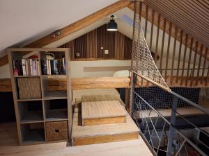a loft bed with a hammock in a room at Appartement Duplex les Cerisiers - Bilhac in Polignac