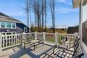 a deck with two chairs and a table on it at Arbor-Lyn --- 19319 Loblolly Cir. in The Plantations