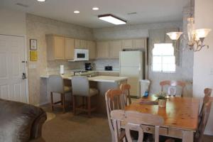 a kitchen with a wooden table and a dining room at Four Seasons Luxury condo on the Lake in Lake Ozark