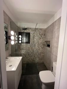 a bathroom with a sink and a toilet at Casa Picacho in Tinajo