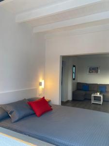 a bedroom with a large bed with a red pillow at Casa Picacho in Tinajo