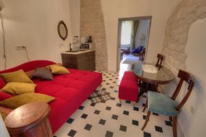 a living room with a red couch and a table at Petrizio Palace in Zadar