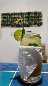 a drink with a lime on a blue table at Casa Gloria Hostal in Bonda