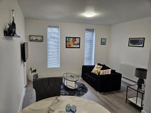 a living room with a couch and a table at Kingdom apartments in Wolverhampton
