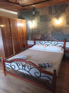 a bedroom with a bed with a wrought iron frame at Zagora MGHouse in Zagora