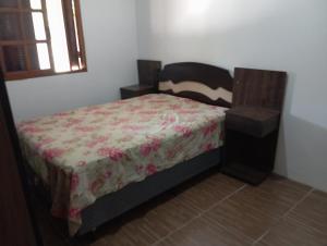 a bedroom with a bed in a room with a window at Casa na praia do cassino in Rio Grande