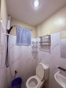 a bathroom with a toilet and a sink at Dau homesite mabalacat pampanga in Mabalacat