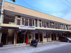 a building with a scooter parked in front of it at Dau homesite mabalacat pampanga in Mabalacat