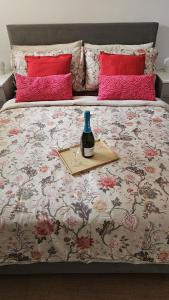 a bed with a bottle of wine on top of it at Modern Flat near Central London! in London