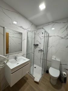 a bathroom with a shower and a toilet and a sink at Bussaco House in Luso +11 photos
