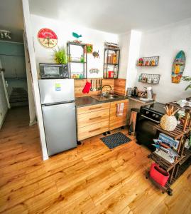 a kitchen with a refrigerator and a sink at Le Bali in La Seyne-sur-Mer