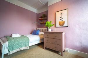 a small bedroom with a bed and a dresser at Ramsgate Family Cottage nr Beach -Harbour- Sleeps 4 - Garden - Parking on Street in Ramsgate