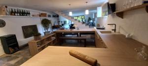 a kitchen with a counter and a table in a room at A Country and Vineyard Retreat in San Martín Sarroca