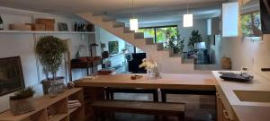 a living room with a table and a staircase at A Country and Vineyard Retreat in San Martín Sarroca