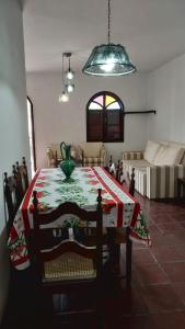 a living room with a table and a couch at Apartamento na praia do forte in Cabo Frio