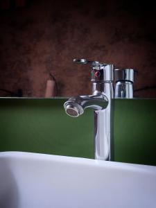 a close up of a bathroom sink with a faucet at Hotel el Descanso in Puebla