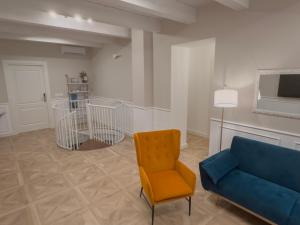 a living room with a blue couch and a chair at B&B Olea Tarsia in Tarsia +24 photos