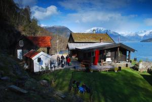 a group of people standing outside of a house at Charming guest house with amazing view in Kvam +52 photos
