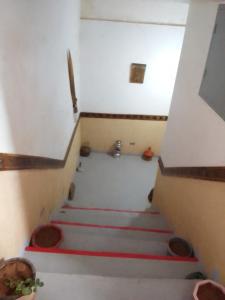 a stairway with red stairs in a room at Ait Sedrate Tourism Cooperative Hotel in Boumalne